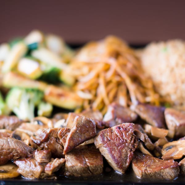 Hibachi Boy's Japanese steak and mushrooms with fried rice, onions, and vegetables.