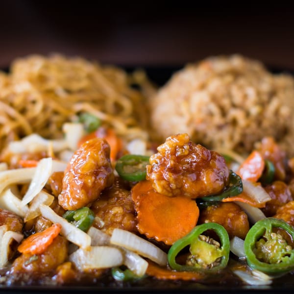 Hibachi Boy's sweet and sour chicken with carrots, onions, jalapeños, lo mein, and fried rice.