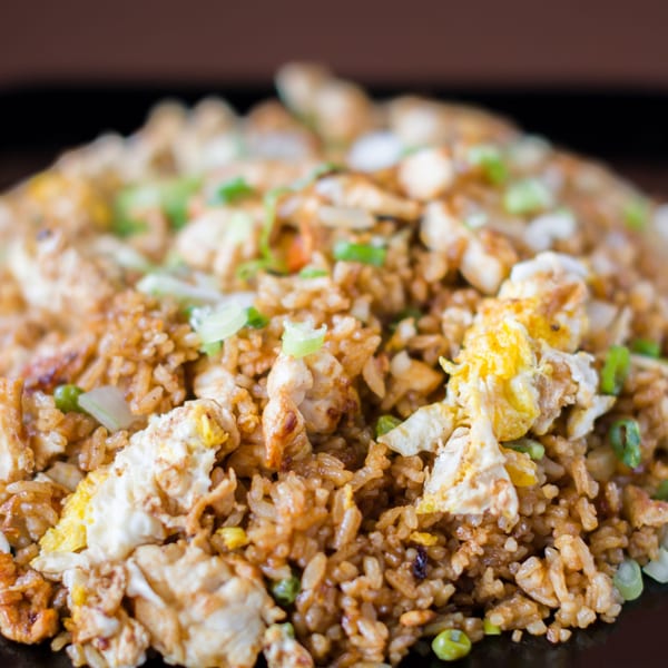 Close-up of Hibachi Boy's chicken fried rice with scrambled egg, peas, and green onions.